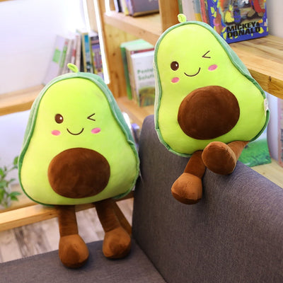 Two avocado plush pillows resting on a couch